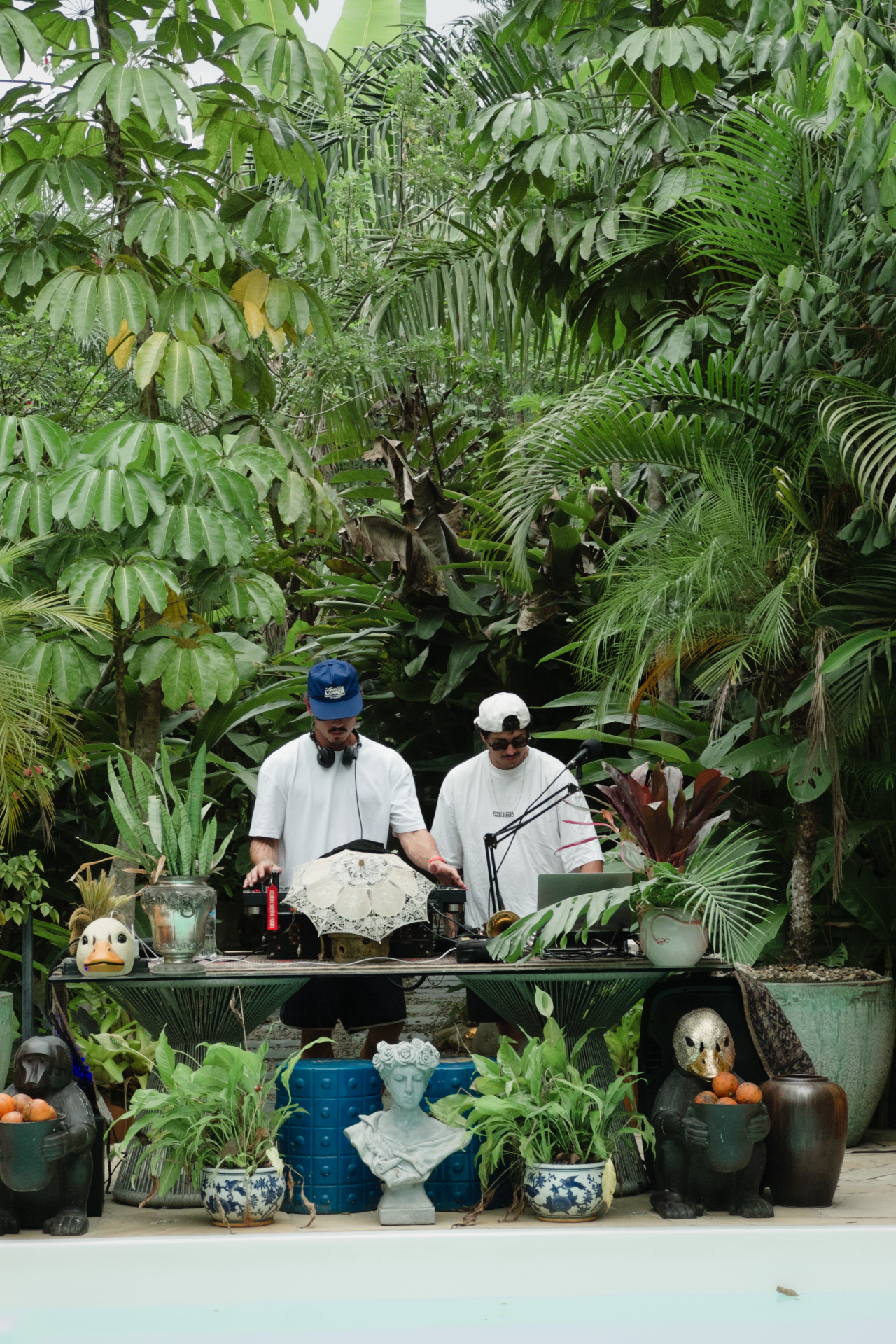 CALLORE DJ performing an open-air set surrounded by tropical foliage